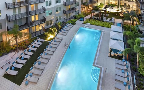 Spacious Pool Deck with Private Cabanas and Outdoor Seating Areas