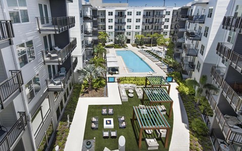 Aerial View of Pool Surrounded by Cabanas, Pergolas, and Lounge Spaces