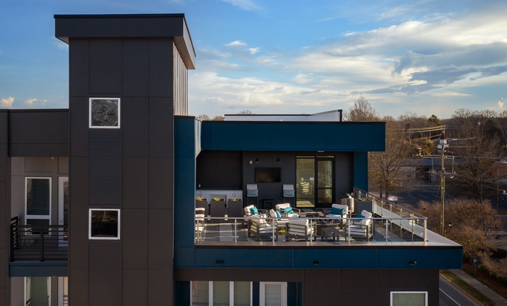 A modern house with a balcony and a chimney.