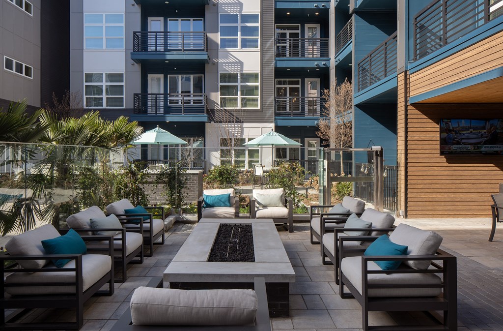 an outdoor patio with chairs and tables and buildings