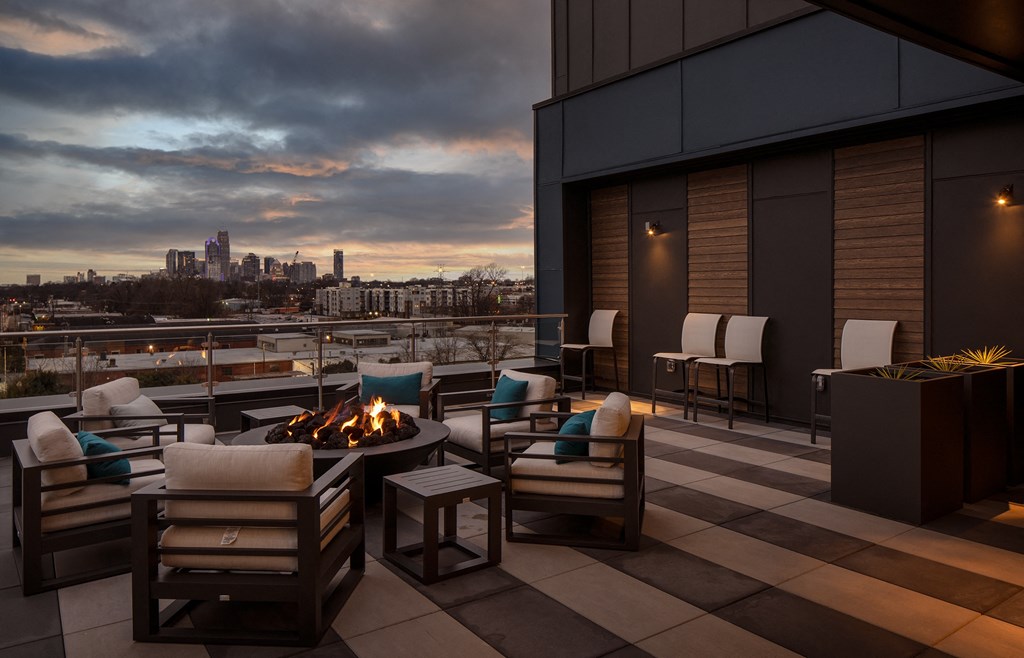 Outdoor Lounge with Fire Feature Overlooking Evening Cityscape