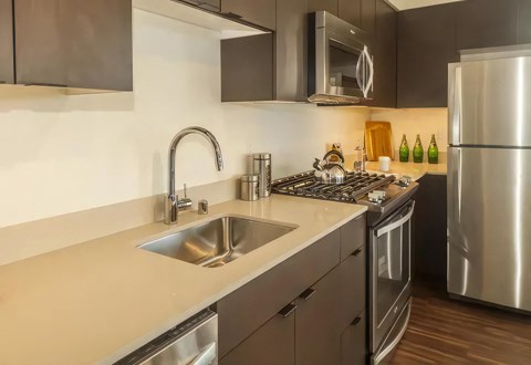 a kitchen with stainless steel appliances and a sink