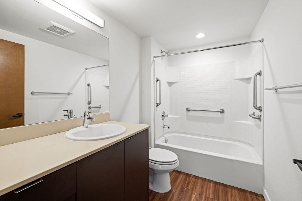 A white bathroom with a sink, toilet, and bathtub.