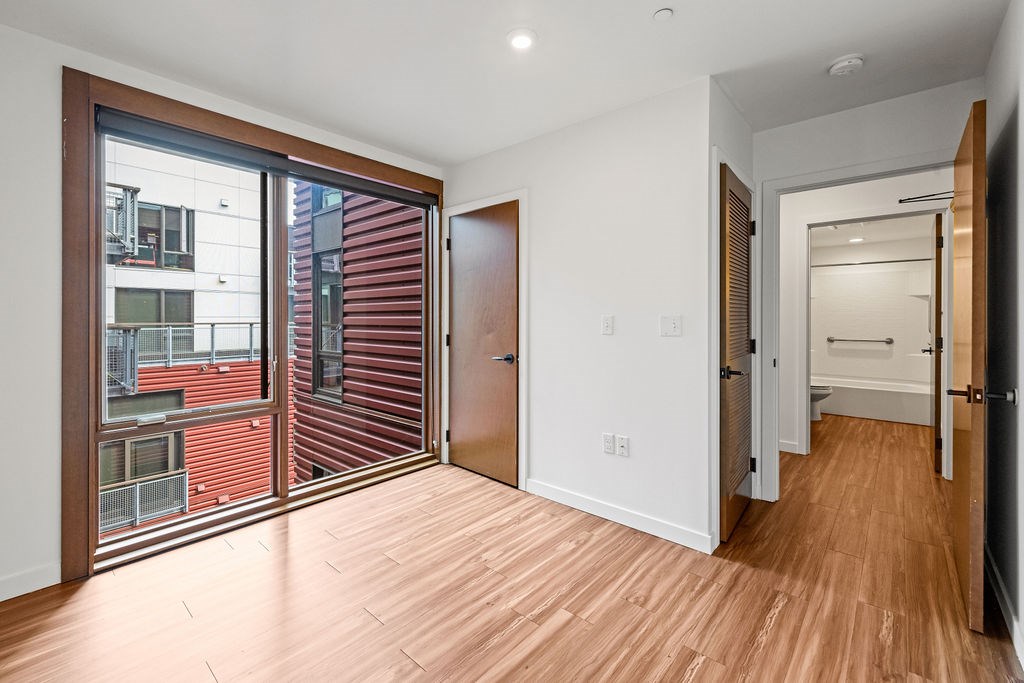 A room with a wooden floor and a white door.