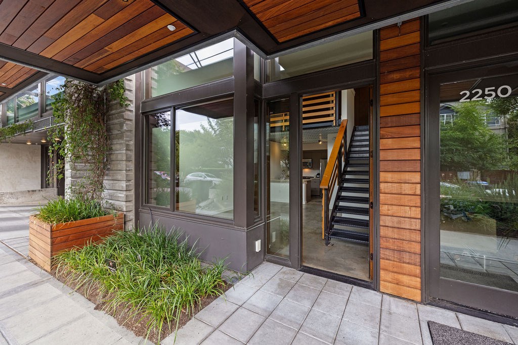 A modern building with a wooden facade and a glass door.