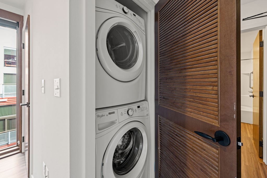 A modern washing machine is built into a wooden door.