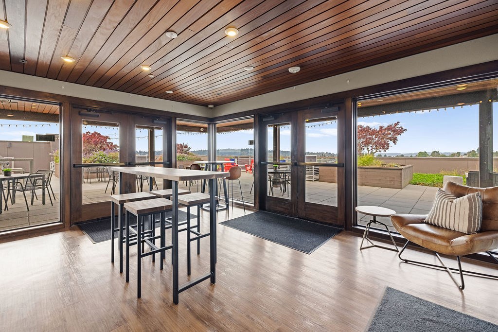 A wooden table with chairs is in a room with a wooden ceiling and floor.