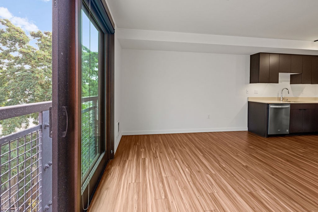 A room with wooden flooring and a white wall.