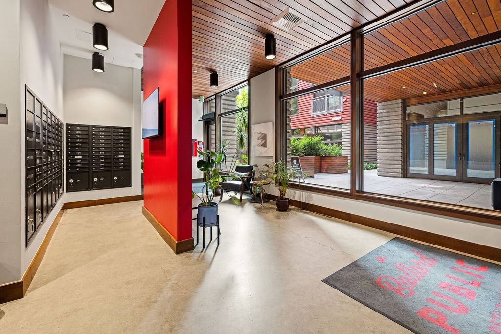 A hallway with a red wall and a black and white checkered floor.