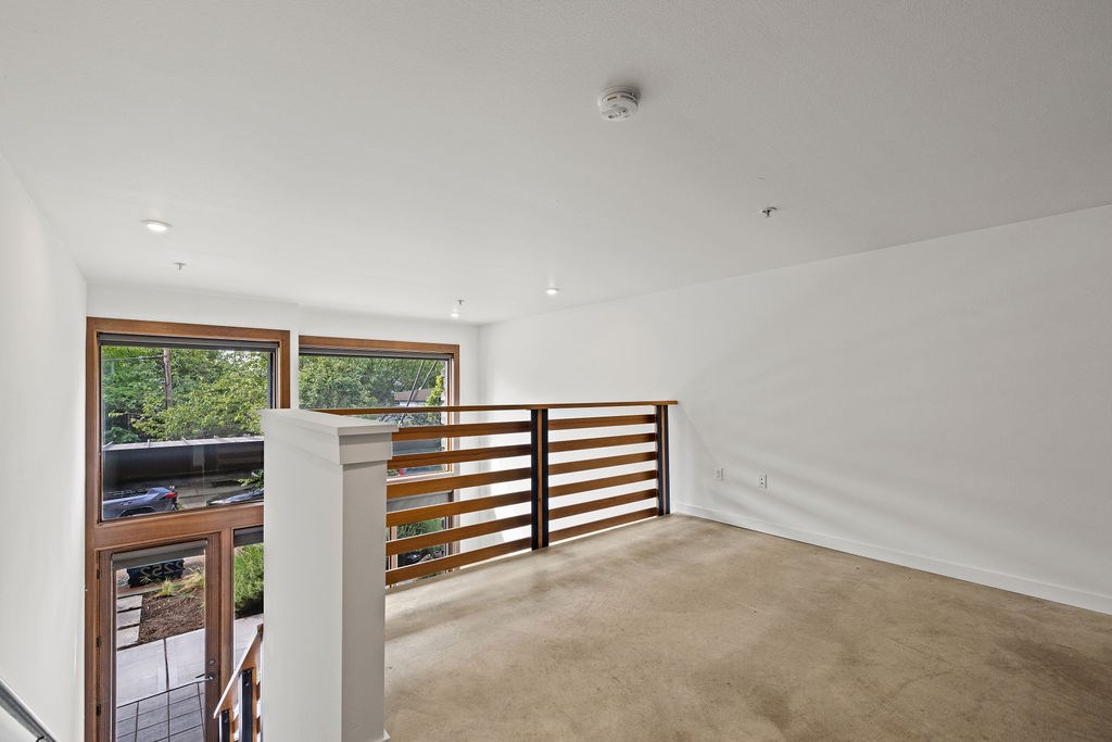 A white room with a window and a balcony.