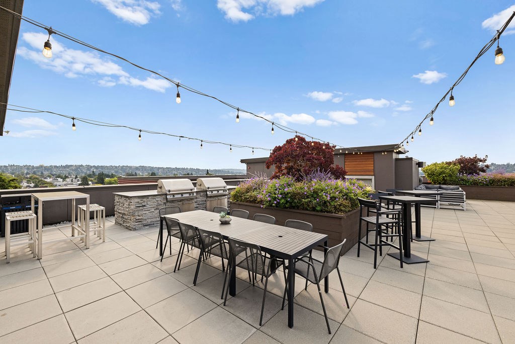 A patio with a table and chairs is set up on a rooftop.