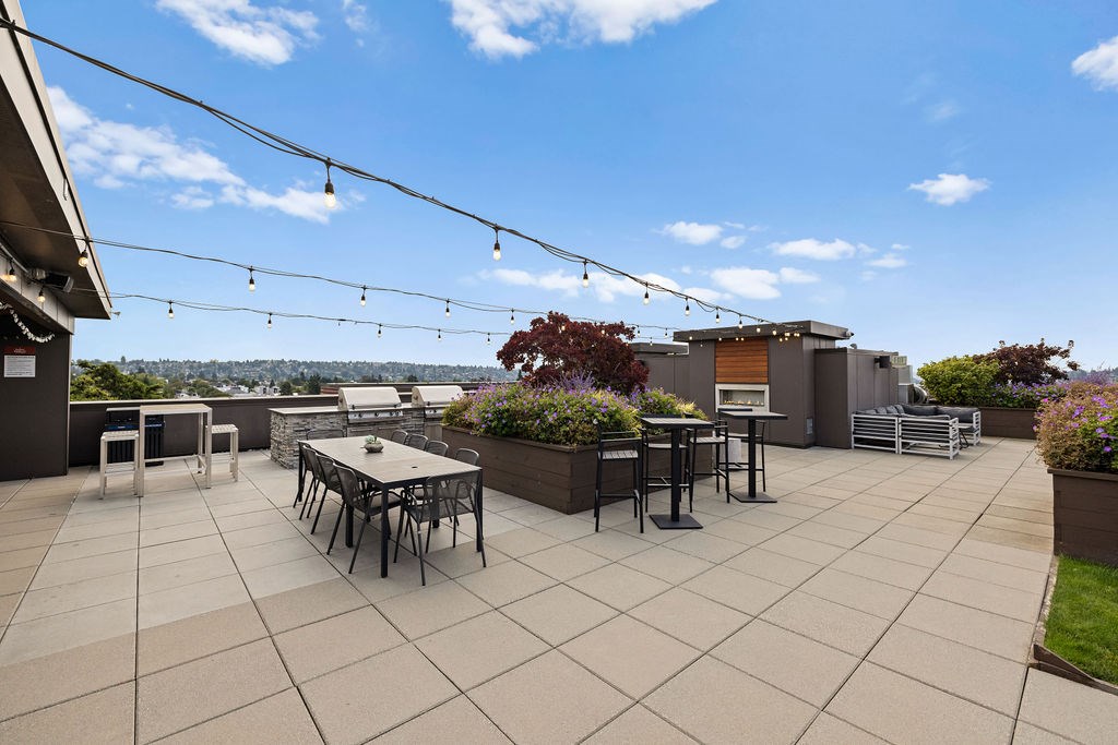 A patio with a table and chairs is set up on a rooftop.
