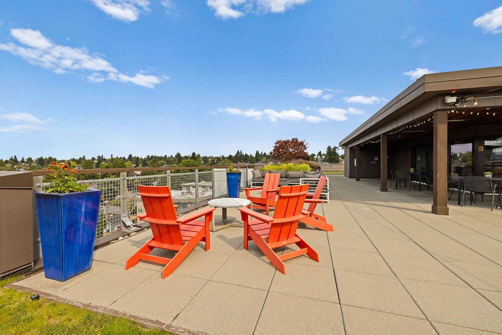 Four orange chairs are arranged on a patio.