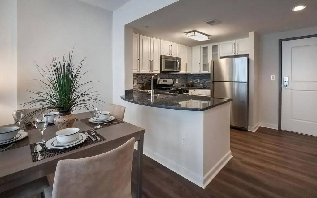 Dining Table and Kitchen With Granite Counters and Stainless Appliances
