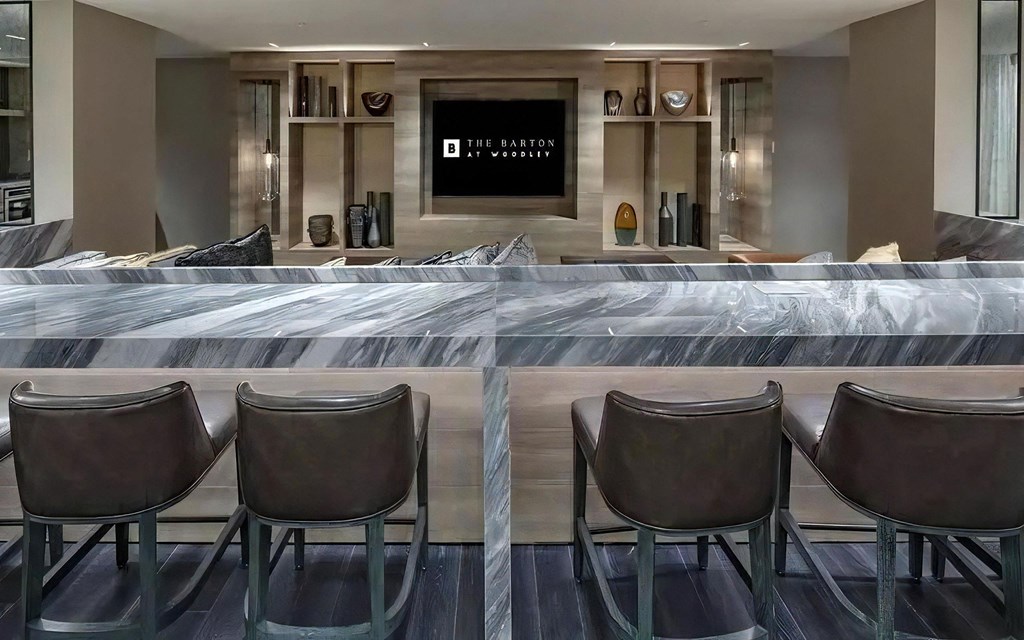 Bar-Style Lounge Area in Clubhouse Facing Built-In Shelving and TV