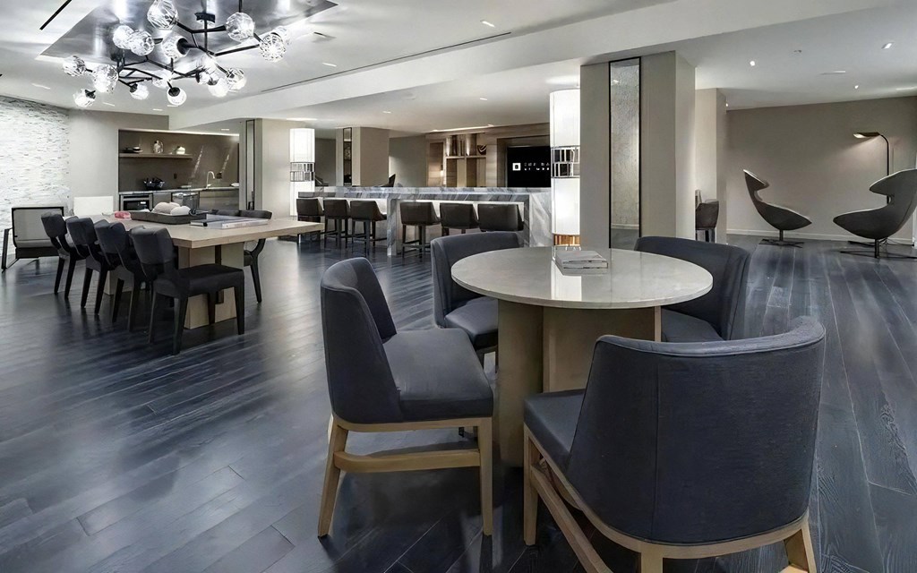 Clubhouse With Multiple Seating Areas, Tables, and Statement Lighting
