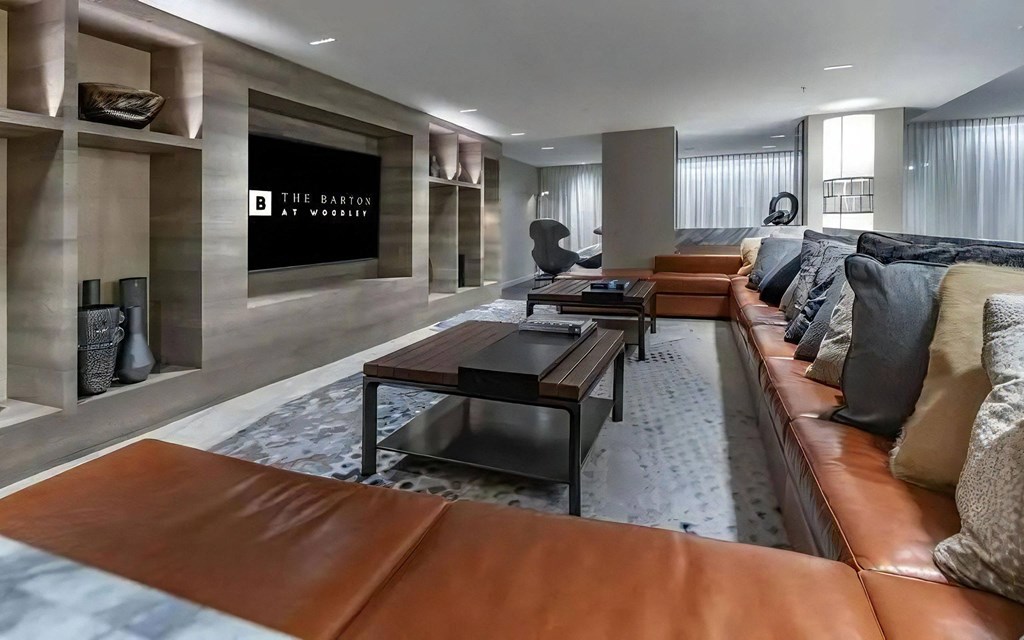 Community Room Featuring Couch Seating, Coffee Tables, and Wall-Mounted TV