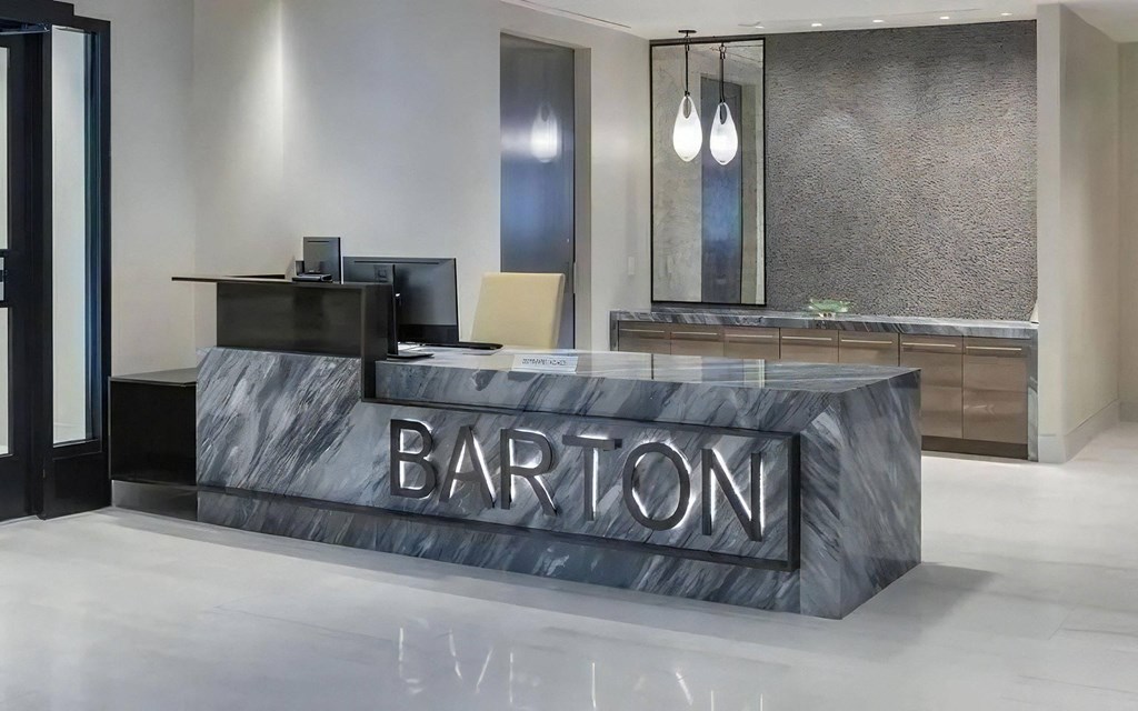 Resident Services Desk With Computer Stations and Pendant Lights