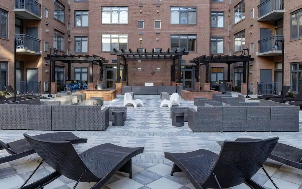 Courtyard With Outdoor Kitchens, Fire Pits, and Pergola Seating