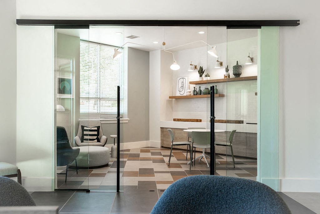 a living room and dining room with glass doors