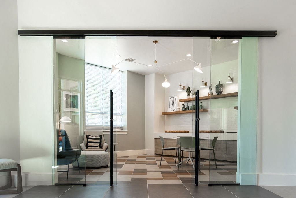 a living room and dining room with glass sliding doors
