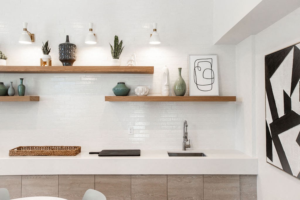 a white kitchen with shelves and a sink