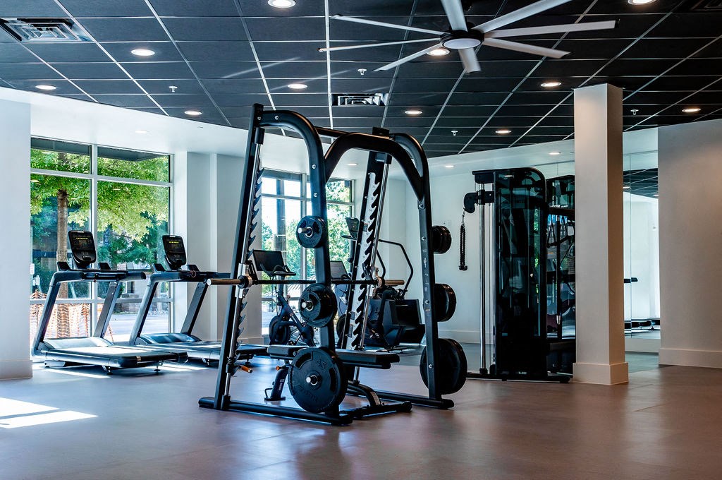 a gym with weights and other exercise equipment on the floor