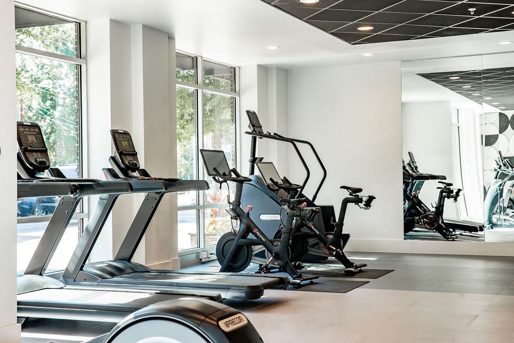 a gym with treadmills and other exercise equipment