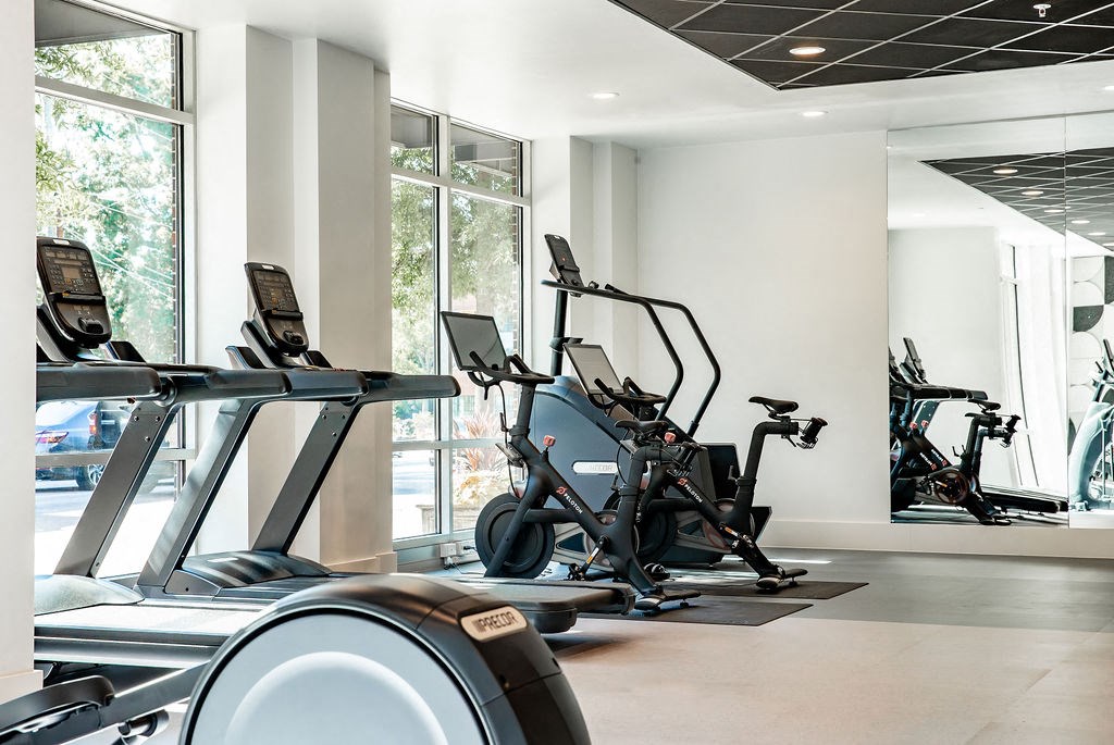a gym with treadmills and other exercise equipment