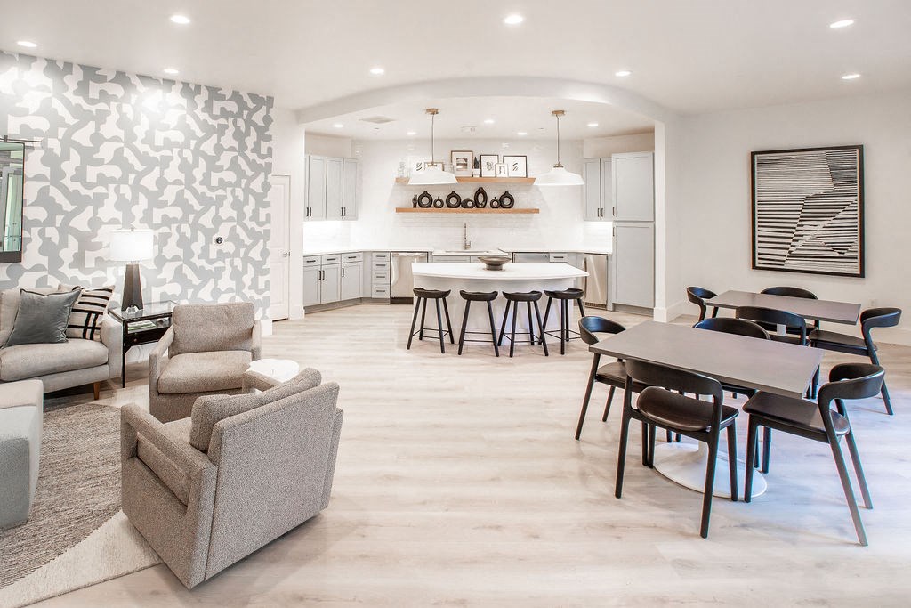 a living room and kitchen with a table and chairs
