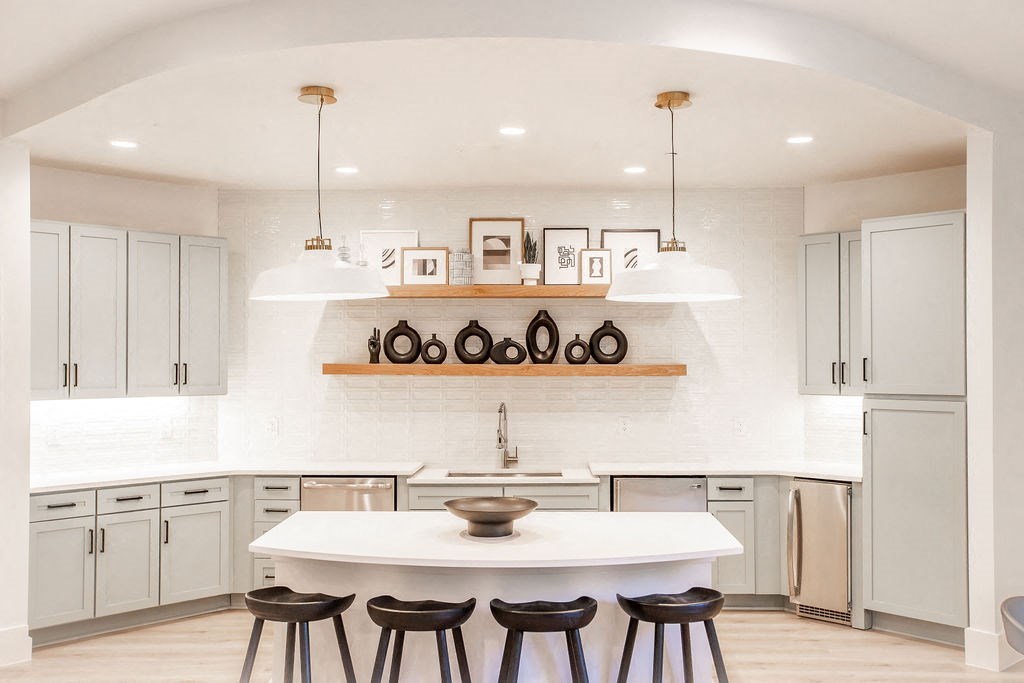 a kitchen with white cabinets and a white counter top