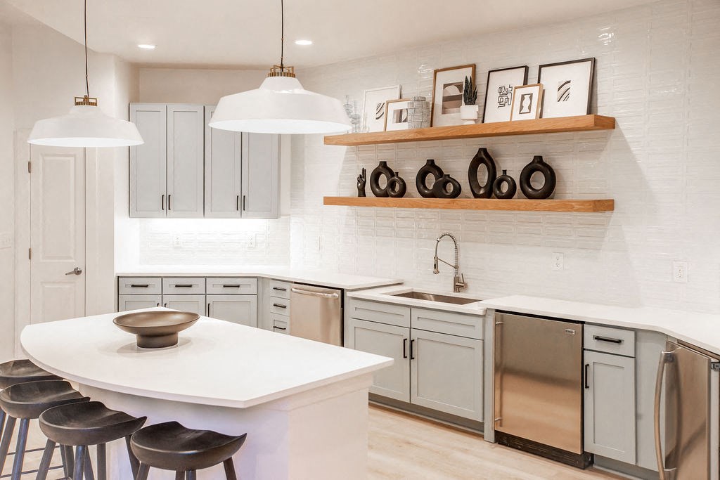 a kitchen with a white counter top and a sink