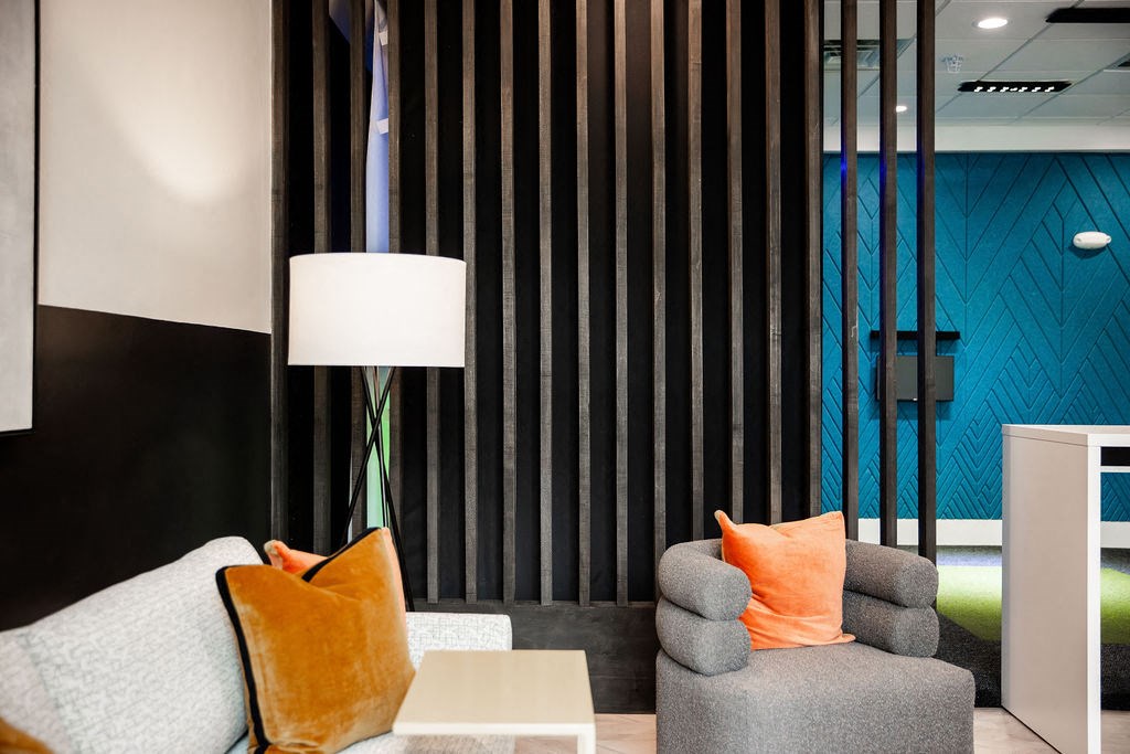 a living room with a couch and a lamp