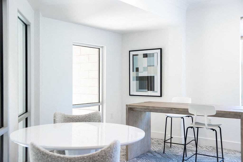 a dining room with a table and chairs and a window