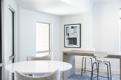 Shared Work Area Featuring Bar Seating and Round Meeting Table