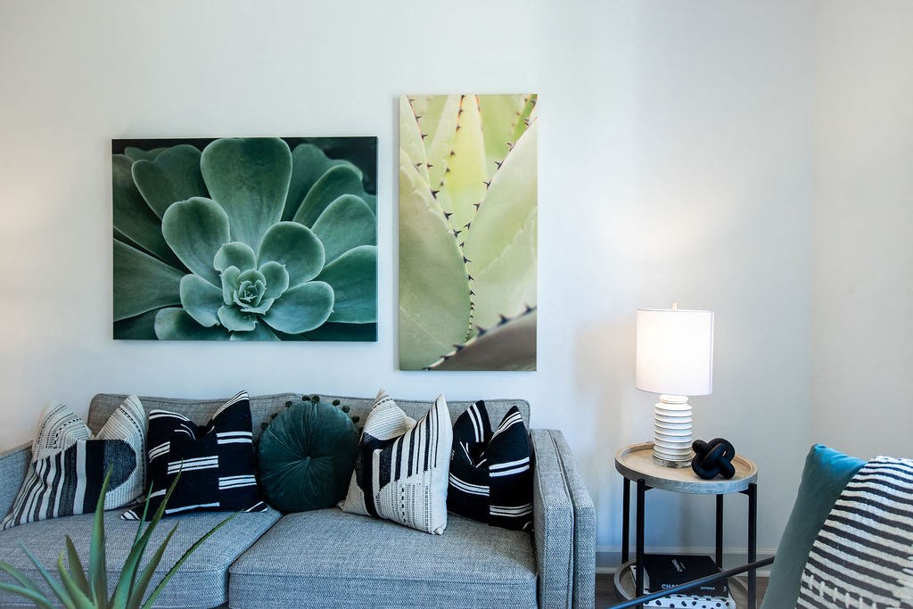 a living room with pictures on the wall and a couch