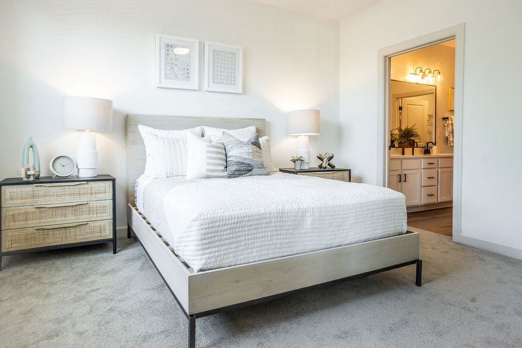 a bedroom with a bed and a mirror