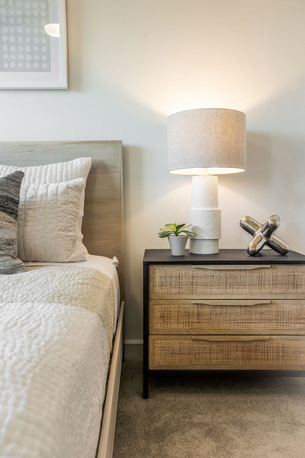 a bedroom with a bed and a night stand with a lamp