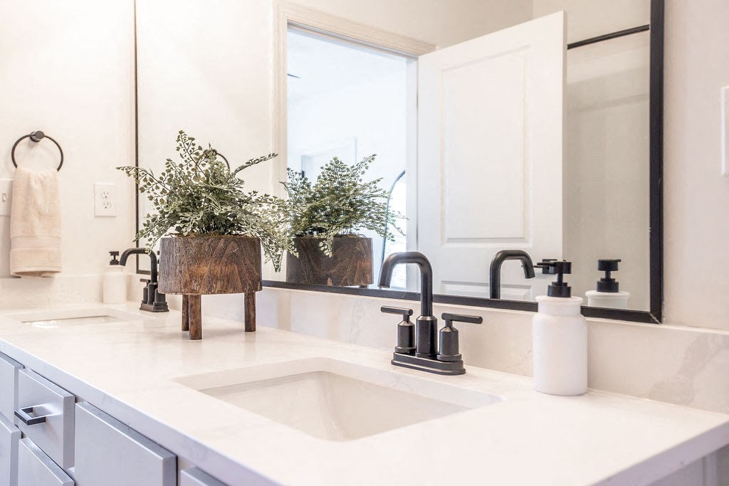 a white bathroom with a sink and a mirror