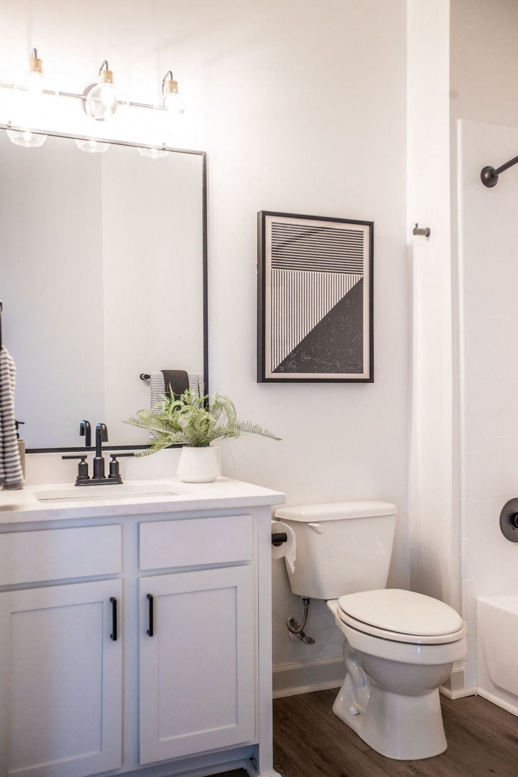 a black and white bathroom with a toilet and a sink