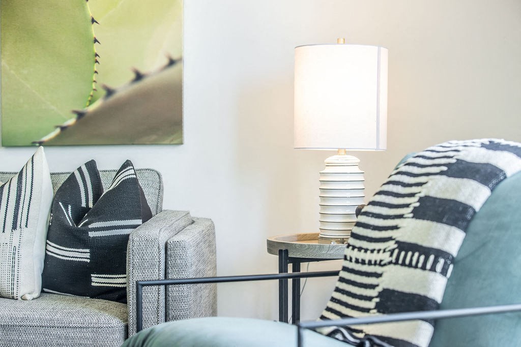 a living room with a couch and a lamp