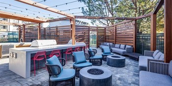 Apartments for Rent Rancho Cucamonga - The Angelica - Outdoor Lounge with Seating and Tables Surrounding Fire Pit - Photo Gallery 3