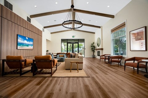 a large living room with furniture and a chandelier