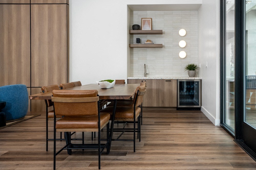 Built-In Lounge Kitchen with Sleek Cabinets, Floating Shelves, and Mini Fridge Built-In Lounge Kitchen with Sleek Cabinets, Floating Shelves, and Mini Fridge