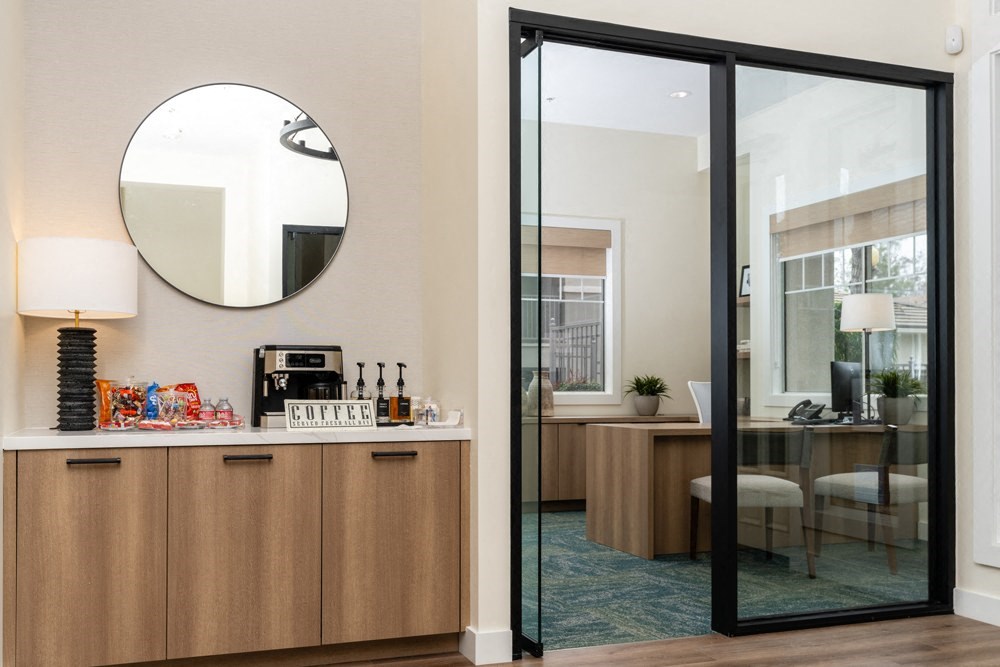 a room with a bar and a mirror and a dining room