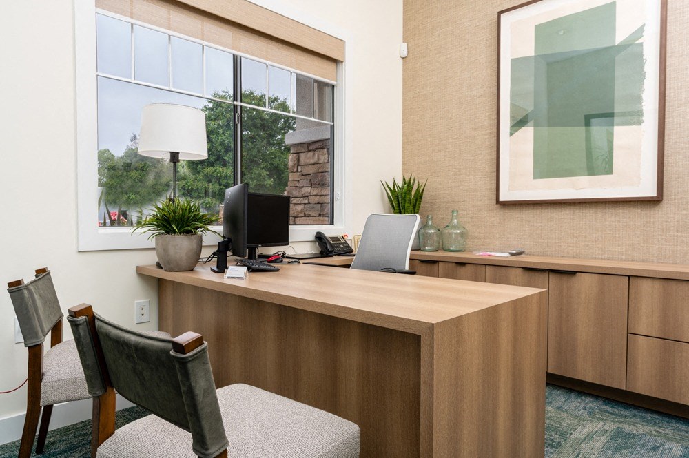 a office with a desk and a window
