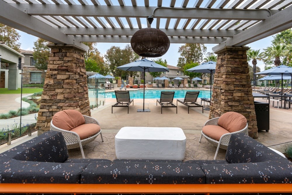 Shaded Poolside Lounge with Comfortable Seating and Pergola Cover Shaded Poolside Lounge with Comfortable Seating and Pergola Cover