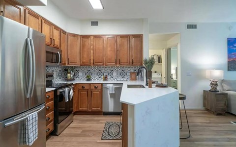 a kitchen with wooden cabinets and stainless steel appliances