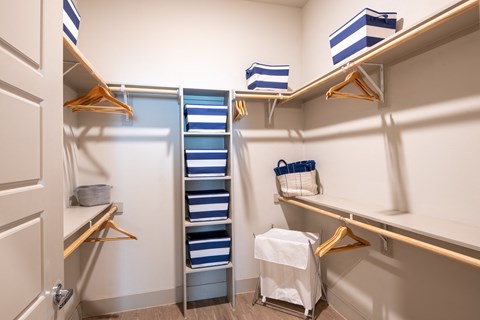Spacious Walk-In Closet with Built-In Shelving and Ample Hanging Space