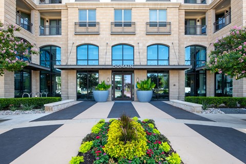 Domain at The Gate Entrance Framed by Flowers and Modern Architecture